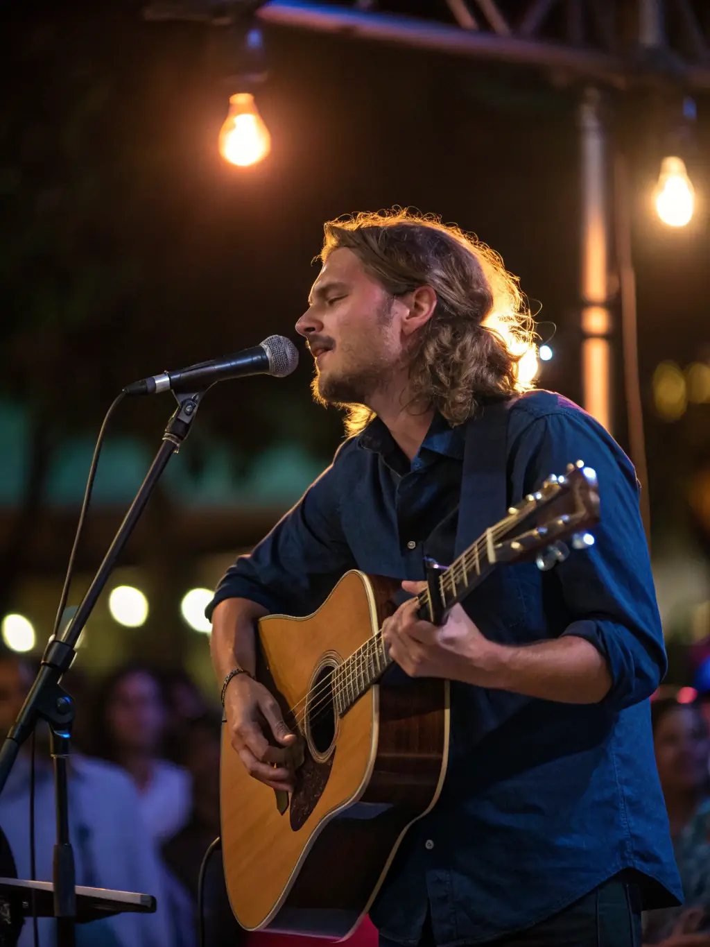 A live performance shot of John Torres playing an instrument on stage, capturing the energy and passion of his live musical performances.